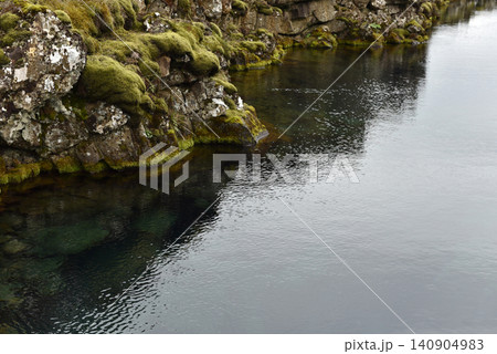 Glacial water filling a rocky volcanic fissure in a mossy rift valley, Iceland Glacial water filling a rocky volcanic fissure in a mossy rift valley, Iceland 140904983