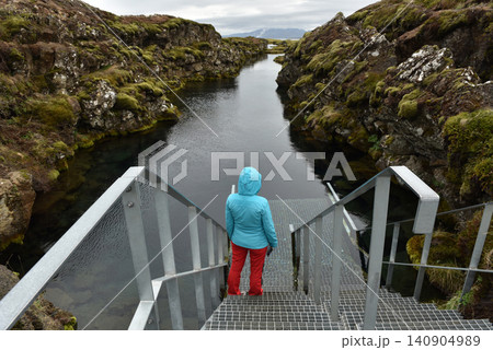 Hiker looking at the Silfra Fissure diving platform, Iceland 140904989
