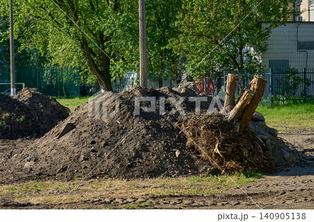 Pile debris garbage.Remove earthen ground before laying asphalt 140905138