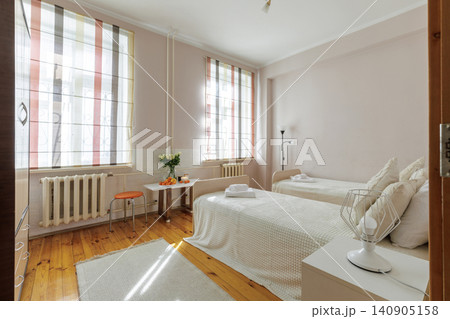 Cozy Twin Bedroom Interior with Dining Corner and Natural Light Cozy Twin Bedroom Interior with Dining Corner and Natural Light 140905158