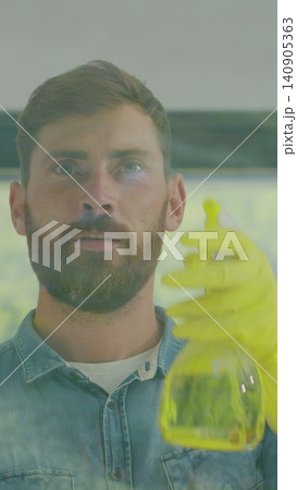 Vertical Video Man removing cleaning solution from glass with special tool, cleaning service. Vertical Video Man removing cleaning solution from glass with special tool, cleaning service. 140905363