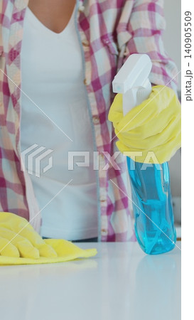 Vertical Video Cleaning the kitchen. Housekeeper washes the kitchen table. 140905509