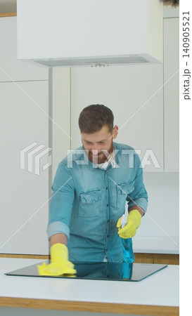 Vertical Video Cleaning service team man and woman at work in kitchen. 140905521