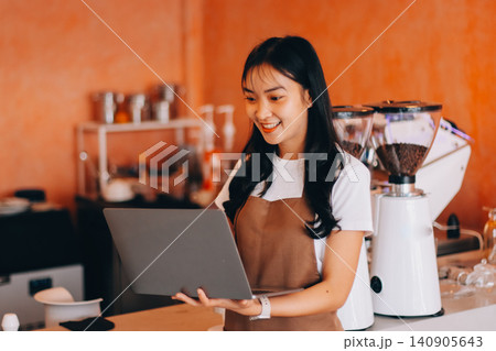 Young woman at barista school learning how to make espresso coffee. 140905643