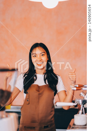 Young woman at barista school learning how to make espresso coffee. 140905654
