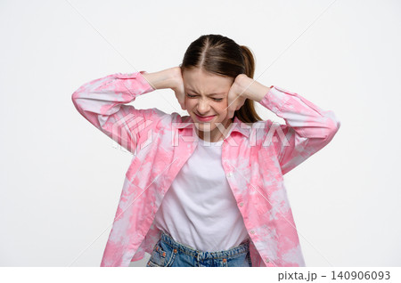 Teenage girl covering ears and ignoring loud noise 140906093