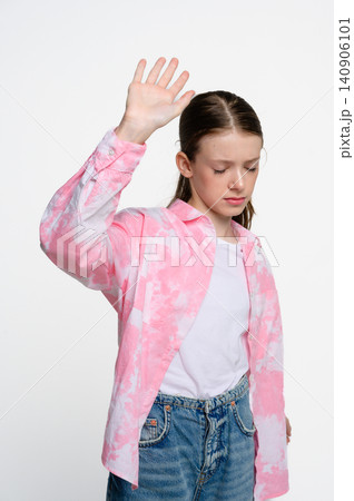 Teenage girl raising hand with stop gesture Teenage girl raising hand with stop gesture 140906101