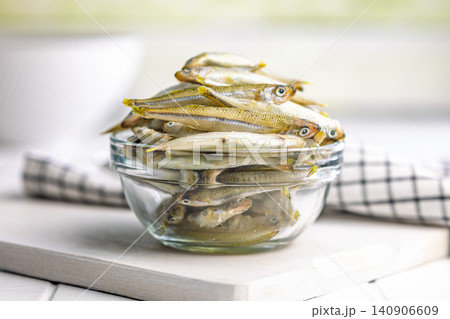Fresh Small Fish Pile in Glass Bowl on Kitchen Table Ready for Cooking or Seafood Preparation Fresh Small Fish Pile in Glass Bowl on Kitchen Table Ready for Cooking or Seafood Preparation 140906609