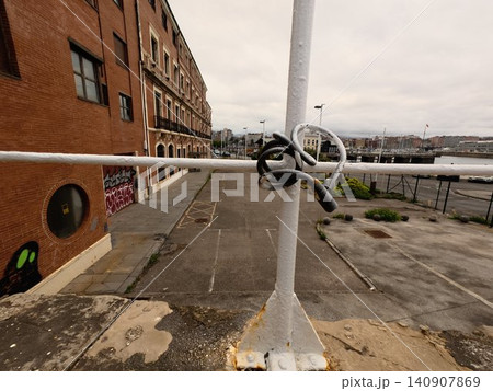 Urban Industrial Waterfront Scene with Security Cable Lock and City Architecture Background Urban Industrial Waterfront Scene with Security Cable Lock and City Architecture Background 140907869
