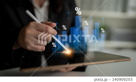Business professional analyzing data trends on a tablet with digital graphs showing growth percentages and market fluctuations in a modern office setting Cyphers. 140909203