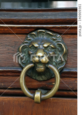Antique Lion Head Door Knocker on Wooden Door for Vintage Home Decor and Architecture Antique Lion Head Door Knocker on Wooden Door for Vintage Home Decor and Architecture 140909361