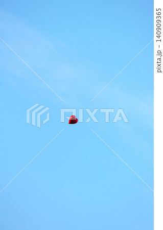 Solitary Red Heart Balloon in Blue Sky - Symbol of Love and Freedom Solitary Red Heart Balloon in Blue Sky - Symbol of Love and Freedom 140909365