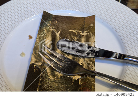 Remnants of a Decadent Dessert on a Plate with Fork and Knife - Dining Experience Remnants of a Decadent Dessert on a Plate with Fork and Knife - Dining Experience 140909423