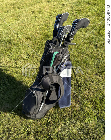 Golf Bag With Clubs on Grassy Area During Sunny Day Golf Bag With Clubs on Grassy Area During Sunny Day 140909743