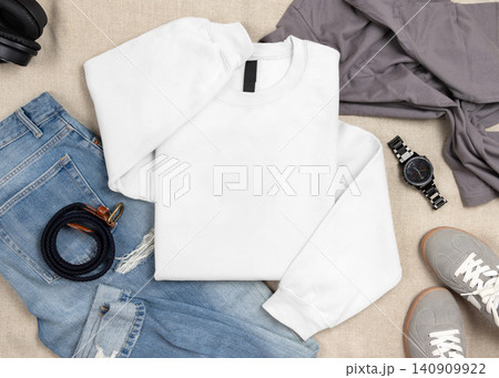 Blank white unisex sweatshirt mockup, folded crewneck with denim jeans and mens accessories Blank white unisex sweatshirt mockup, folded crewneck with denim jeans and mens accessories 140909922