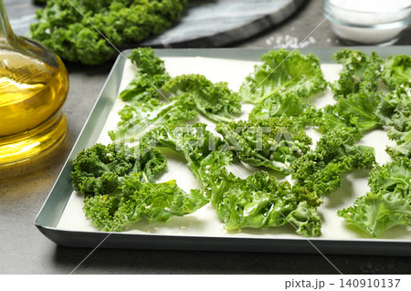 Raw cabbage leaves on grey table, closeup. Preparing kale chips 140910137