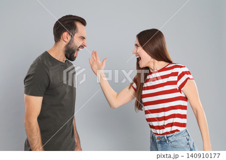 Couple quarreling on grey background. Relationship problems Couple quarreling on grey background. Relationship problems 140910177