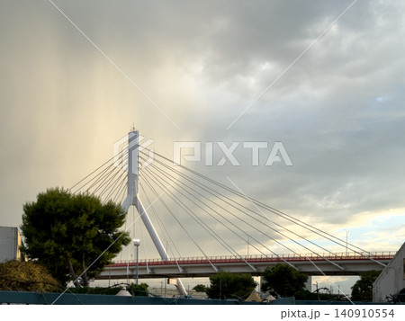 Modern architectural bridge in Bari cityscape under storm clouds 140910554