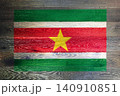 Suriname flag on rustic old wood surface background 140910851