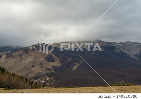 High angle view of a wide mountain valley under cloudy sky in Abruzzo region High angle view of a wide mountain valley under cloudy sky in Abruzzo region 140910880