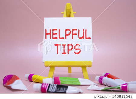 Helpful tips symbol. Wooden blocks with words Helpful tips. Beautiful pink background with paints and easel. Business and Helpful tips concept. Copy space. Helpful tips symbol. Wooden blocks with words Helpful tips. Beautiful pink background with paints and easel. Business and Helpful tips concept. Copy space. 140911548