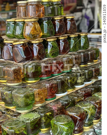 Colorful Herbal Infused Honey in Glass Jars at Local Farmers Market Colorful Herbal Infused Honey in Glass Jars at Local Farmers Market 140911859