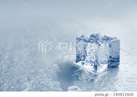 Crystal clear ice cube on grey background, closeup. Space for text Crystal clear ice cube on grey background, closeup. Space for text 140911926