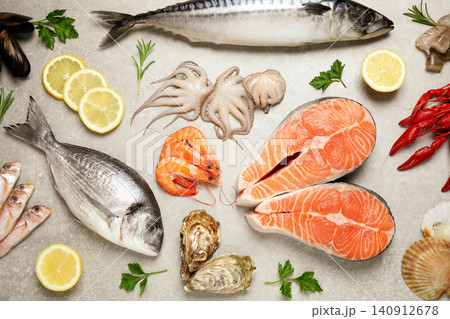 Fresh fish and seafood on light grey table, flat lay Fresh fish and seafood on light grey table, flat lay 140912678