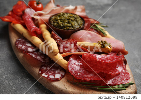 Tasty ham and other delicacies served on grey table, closeup 140912699