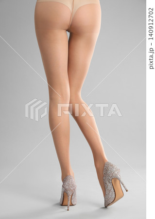 Woman wearing tights and stylish shoes on light grey background, closeup of legs Woman wearing tights and stylish shoes on light grey background, closeup of legs 140912702