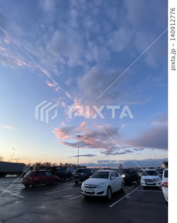 Colorful Sunset Sky with Dramatic Pink Clouds Above Parking Lot Colorful Sunset Sky with Dramatic Pink Clouds Above Parking Lot 140912776