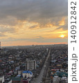 Urban Cityscape at Golden Sunset with Long Straight Avenue 140912842