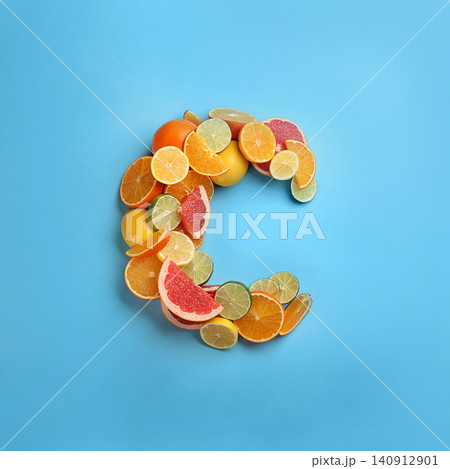 Letter C made with citrus fruits on light blue background as vitamin representation, flat lay Letter C made with citrus fruits on light blue background as vitamin representation, flat lay 140912901