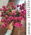 Bouquet of Pink Spray Roses with Hand Touching Flowers 140912954