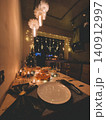 Cozy Christmas Dinner Table Decorated with Candles and Tree 140912997