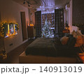 Cozy Christmas Bedroom Decorated with Lights and Christmas Tree 140913019