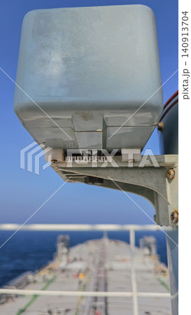 Vertical close up shot of a marine level gauge indicator with a numbered scale on a ship deck, with the blurred bow of the tanker and blue ocean in background Vertical close up shot of a marine level gauge indicator with a numbered scale on a ship deck, with the blurred bow of the tanker and blue ocean in background 140913704