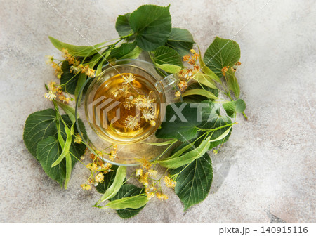 Linden tea with fresh tilia flowers and leaves Linden tea with fresh tilia flowers and leaves 140915116