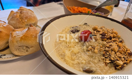 Traditional Portuguese meal with roasted suckling pig and creamy mushroom risotto served in a restaurant. Concepts: local cuisine, gastronomy, travel, culture, and dining. Traditional Portuguese meal with roasted suckling pig and creamy mushroom risotto served in a restaurant. Concepts: local cuisine, gastronomy, travel, culture, and dining. 140915321