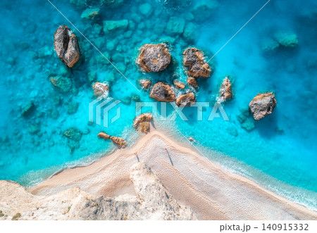 Aerial view of blue sea, rocks in clear water, white sandy beach 140915332
