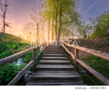 Wooden stairs in forest at sunset in spring. Plitvice Lakes Wooden stairs in forest at sunset in spring. Plitvice Lakes 140915365