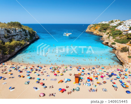 Aerial view of colorful umbrellas on sandy beach, swimming people Aerial view of colorful umbrellas on sandy beach, swimming people 140915445