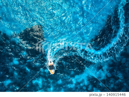Aerial drone view of motorboat with curved wake in turquoise sea Aerial drone view of motorboat with curved wake in turquoise sea 140915446