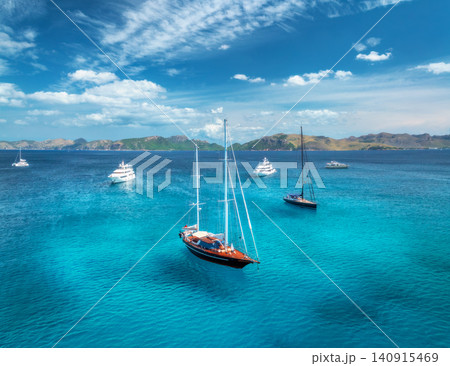 Aerial drone view of yachts and sailboats anchored in blue sea Aerial drone view of yachts and sailboats anchored in blue sea 140915469