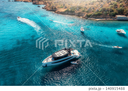 Aerial view of luxury yacht and boat in blue sea in summer Aerial view of luxury yacht and boat in blue sea in summer 140915488