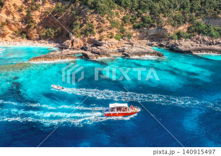Aerial view of red speed boat, turquoise sea, sandy beach. Summer Aerial view of red speed boat, turquoise sea, sandy beach. Summer 140915497