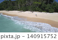Aerial perspective capturing tranquil island coast with forest and ocean meeting 140915752