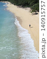 Alone woman wandering barefoot along sunriselit beach with peaceful surroundings 140915757