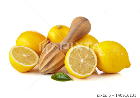 Fresh lemons and wooden juicer isolated on a white background. Fresh lemons and wooden juicer isolated on a white background. 140916133