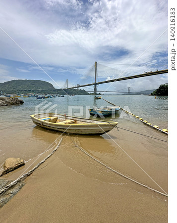 Serene coastal view with boats and bridge under a cloudy sky Serene coastal view with boats and bridge under a cloudy sky 140916183